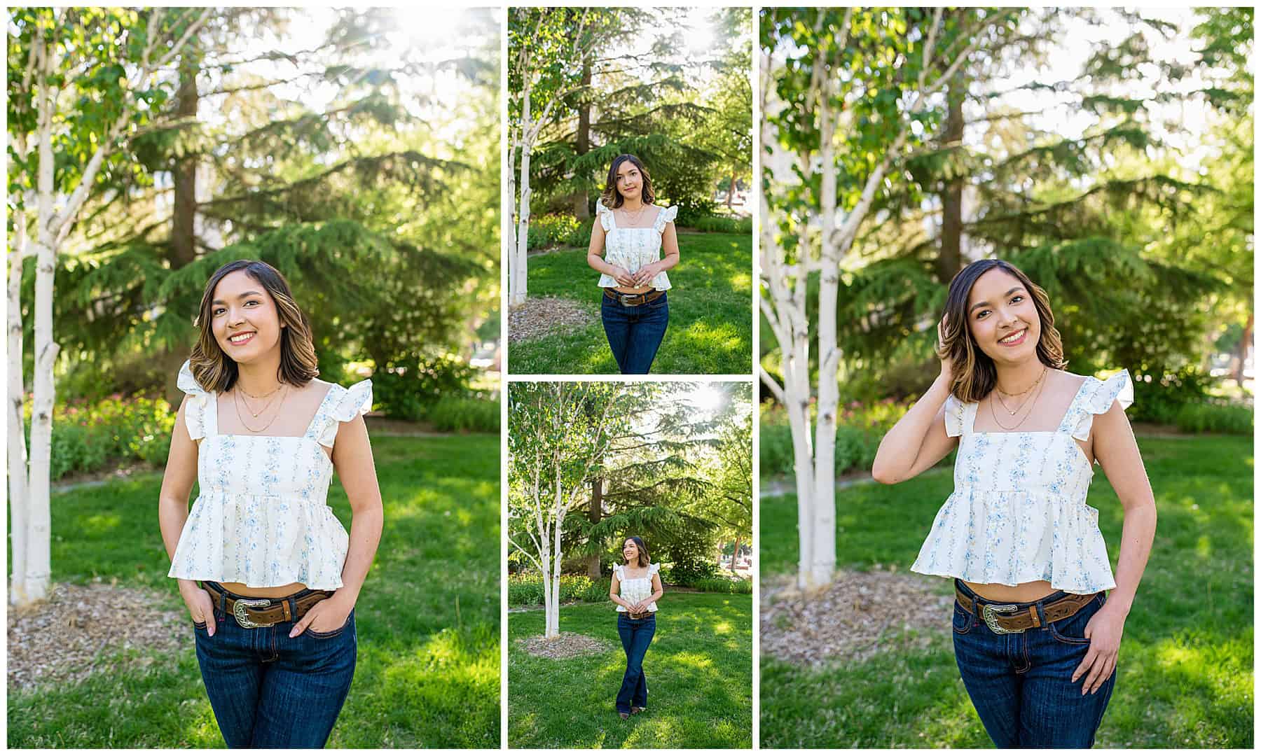 Senior girl in blue jeans, a floral top, cowgirl boots, and a hat posing in lush green grass with trees behind her at UNM in Albuquerque, New Mexico