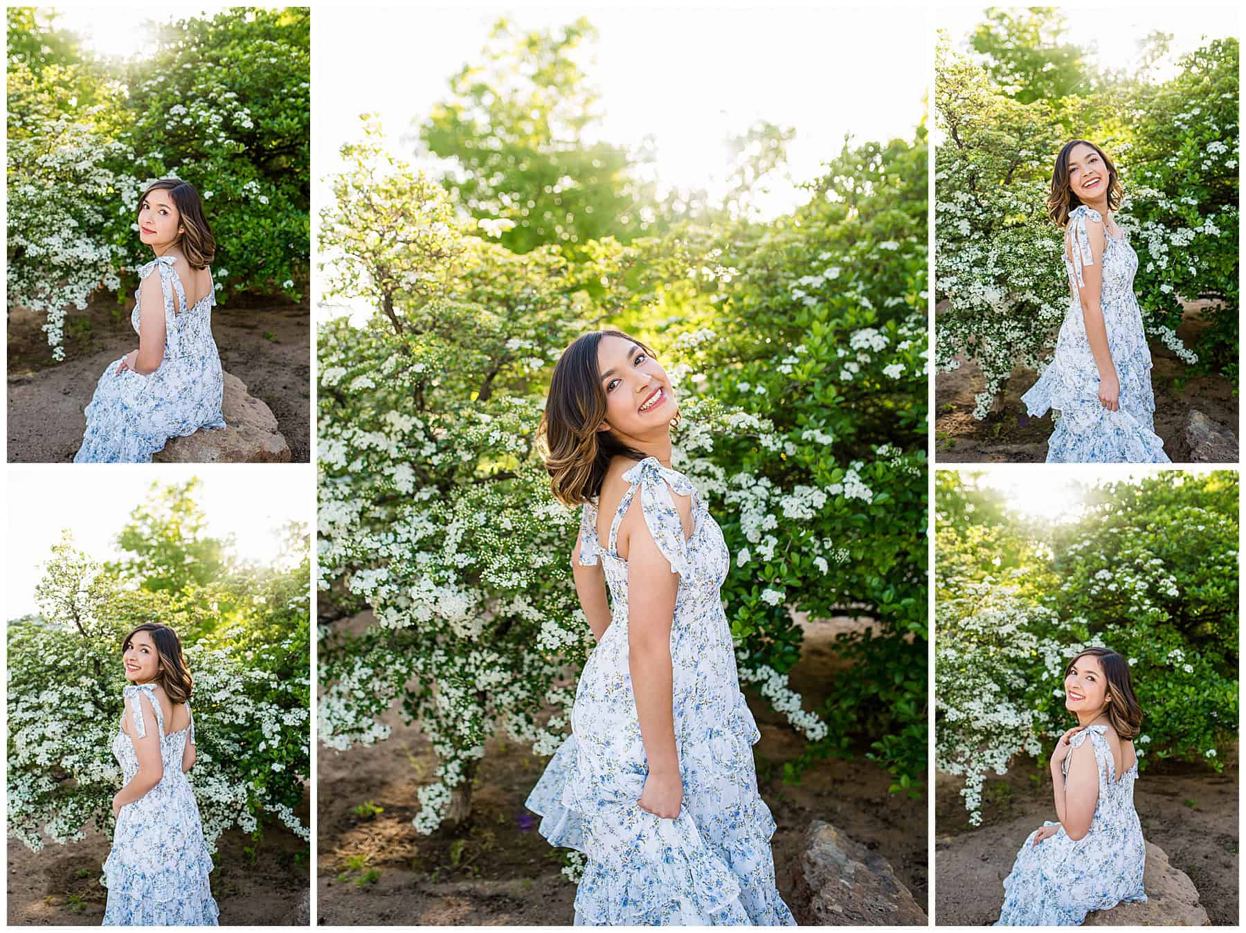 New Mexico High School Senior girl from St. Pius High School smiling in a white and blue dress and boots surrounded by white blossoms at the University of New Mexico.