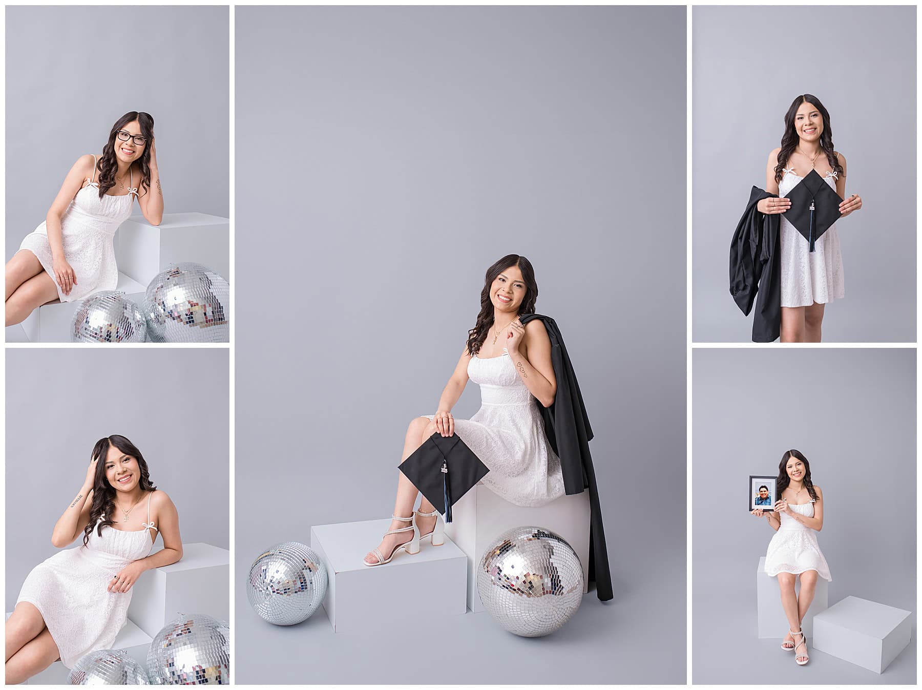 Cleveland High School senior wearing a white dress and cap and gown on a gray studio backdrop at AMP Studio in Rio Rancho, New Mexico.