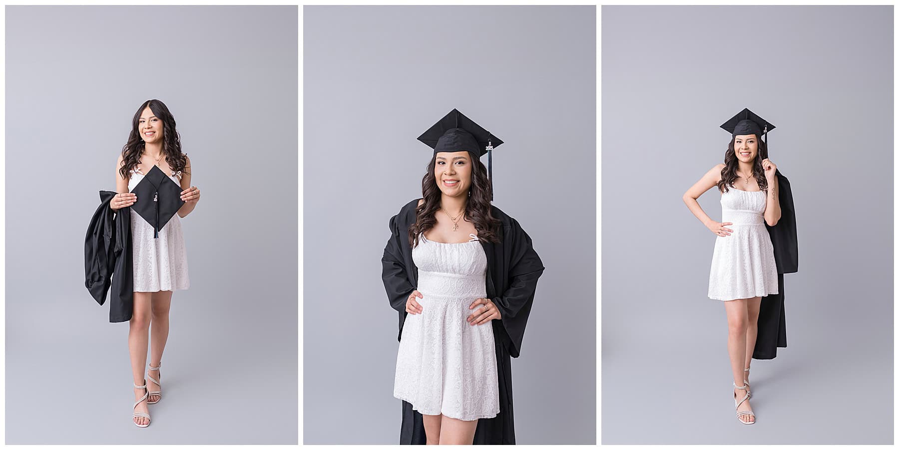 Indoor senior portrait in Albuquerque featuring a Cleveland High senior in a white dress holding her graduation cap on a gray backdrop.