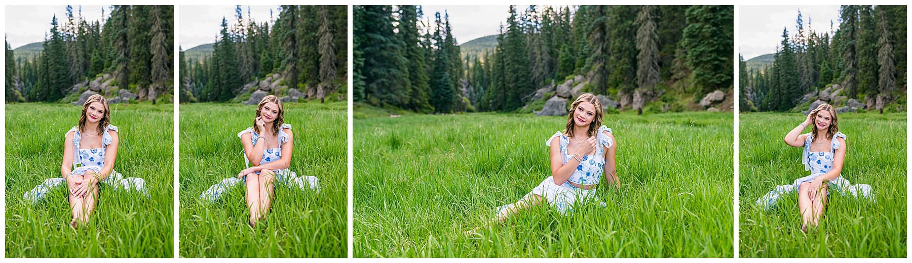 Senior girl walking through tall green grass in New Mexico, sunlit mountains behind her, holding her dress and smiling.